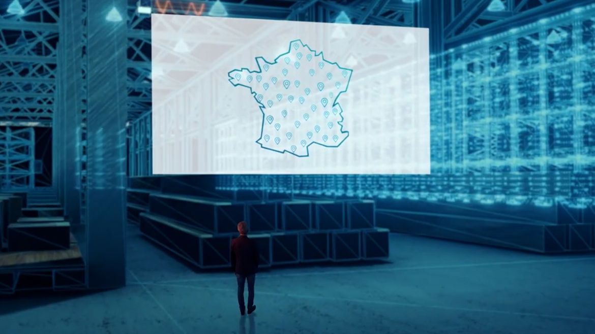 Man looking at a France map on a giant screen.