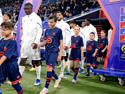 OL players and children entering the field during an OL match.